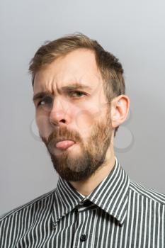 Adult man with bad manners - showing his tongue.