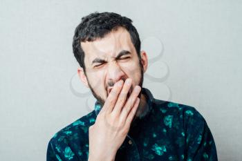 Young man with beard  yawning
