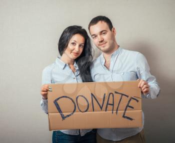 Portrait of a happy young couple with donation