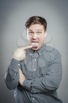 young man with finger in tongue