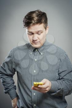 Young man dials number on phone
