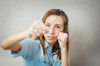 pretty young girl  posing with fists gesturing fight 