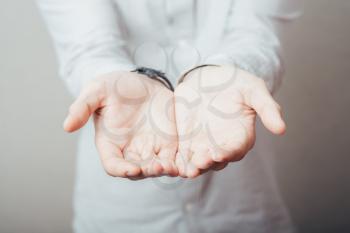 man's hands holding something invisible