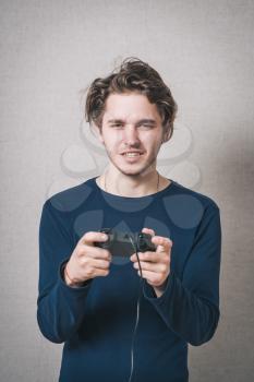 A man playing a video game. Gray background
