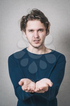 Man showing empty hands. Gray background