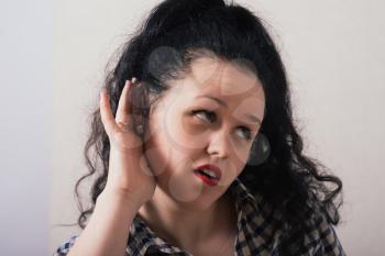 Young woman trying to listen something
