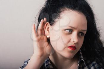 Young woman trying to listen something