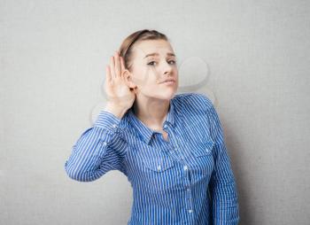 Young woman surprised trying to hearing something