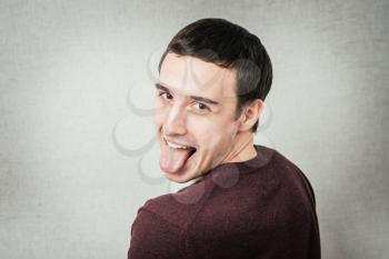 man shows tongue