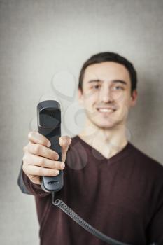 Man holding a landline telephone receiver