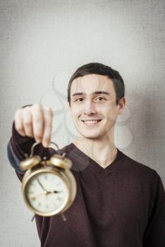 young man holding an alarm clock
