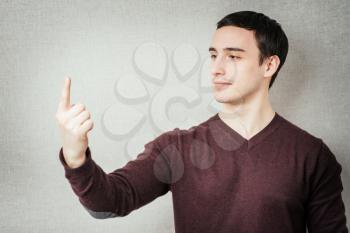 Young man . Raised hand is pointing to the top. gesture. photo shoot.