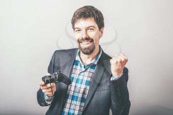 bearded businessman playing on the joystick console