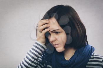 young girl in depression holding his head