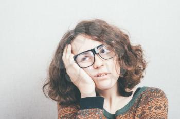 Girl tired and holding his head with glasses