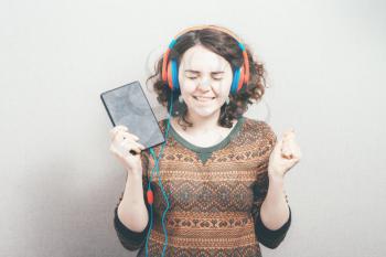 woman in headphones and a tablet