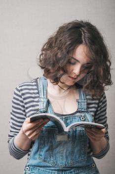 girl holding and reading a book