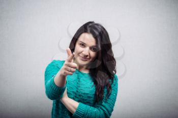 young  woman pointing at someone gesture with finger