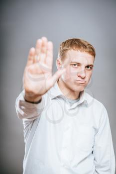 angry attractive young man showing stop hand