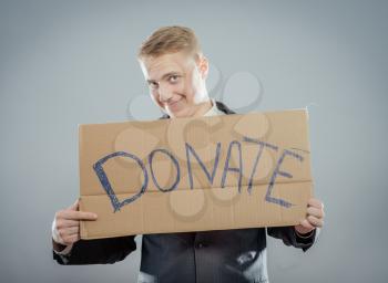 mansmile and holding Cardboard text a donate