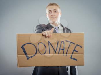 man holding Cardboard text a donate