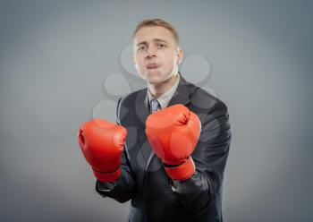 businessman in boxing gloves cause to fight isolated 