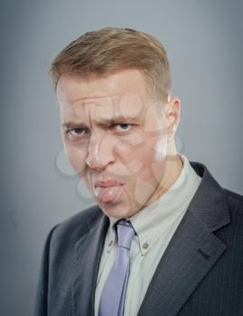 Portrait of a young businessman with tongue piercing 