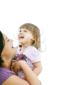 Mother and daughter smiling isolated over a white background. Focus in the little girl.