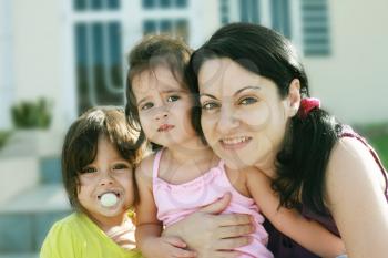 Mother and Daughters portrait outdoors in front of their home