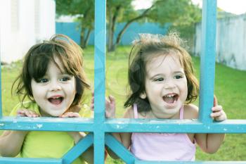 Portrait of happy two sisters outdoors having fun
