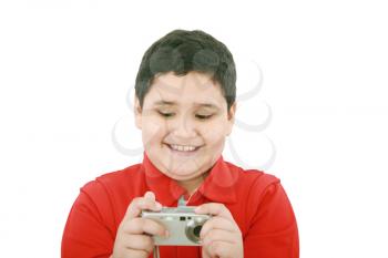 small boy with digital camera on white background 
