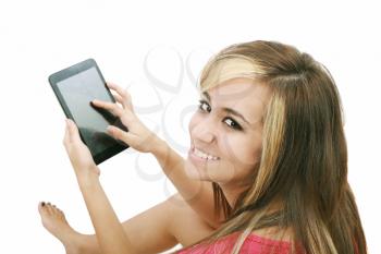 Overhead photograph of a beautiful young women sitting on floor using a tablet PC computer and smiling