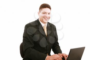 Portrait of businessman in front of laptop computer 
