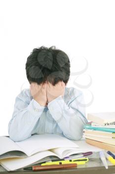 Stressed schoolboy studying in classroom 