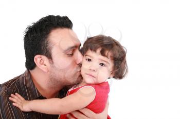 Father hugging and kissing little daughter, smiling. 
