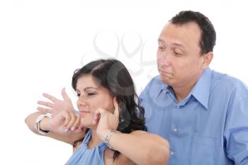 Portrait of a young woman gets earful from her husband against white background 