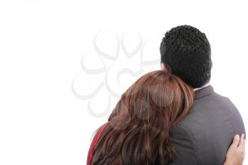Rear view of a loving couple standing with arms around 