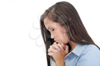 A young woman praying with her hands together on white background 