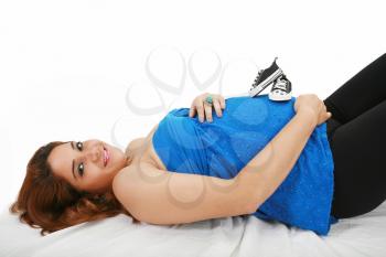 Beautiful pregnant woman lying on the bed
