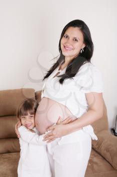 Portrait of Pregnant woman with her daughter