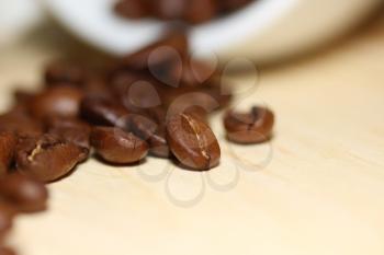 Macro shot of roasted coffee grains on a table