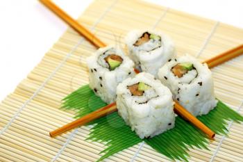 4 rolls of sushi, in a zen attitude