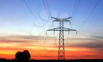 Electricity pylons, over a sunset sky