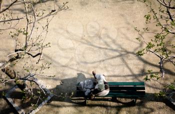 Top view of a man sitting on a bench
