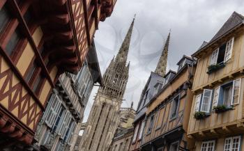 Street in Quimper with a view of the Cathedral of Saint Corentin, Brittany, France