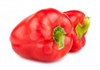 Two red ripe sweet peppers isolated on white background