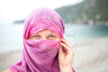 Royalty Free Photo of a Woman With Her Face Covered By a Scarf