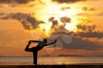 Royalty Free Photo of a Man Doing Yoga on a Beach