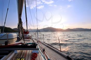 Royalty Free Photo of a Sailing Boat at Sunset