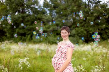 Royalty Free Photo of a Pregnant Woman in a Field